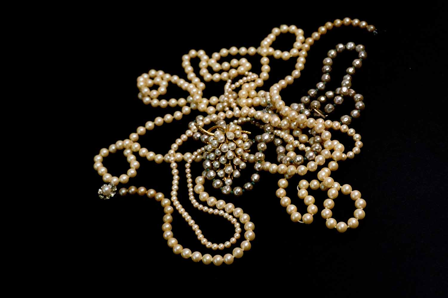 a group of pearls on a black surface